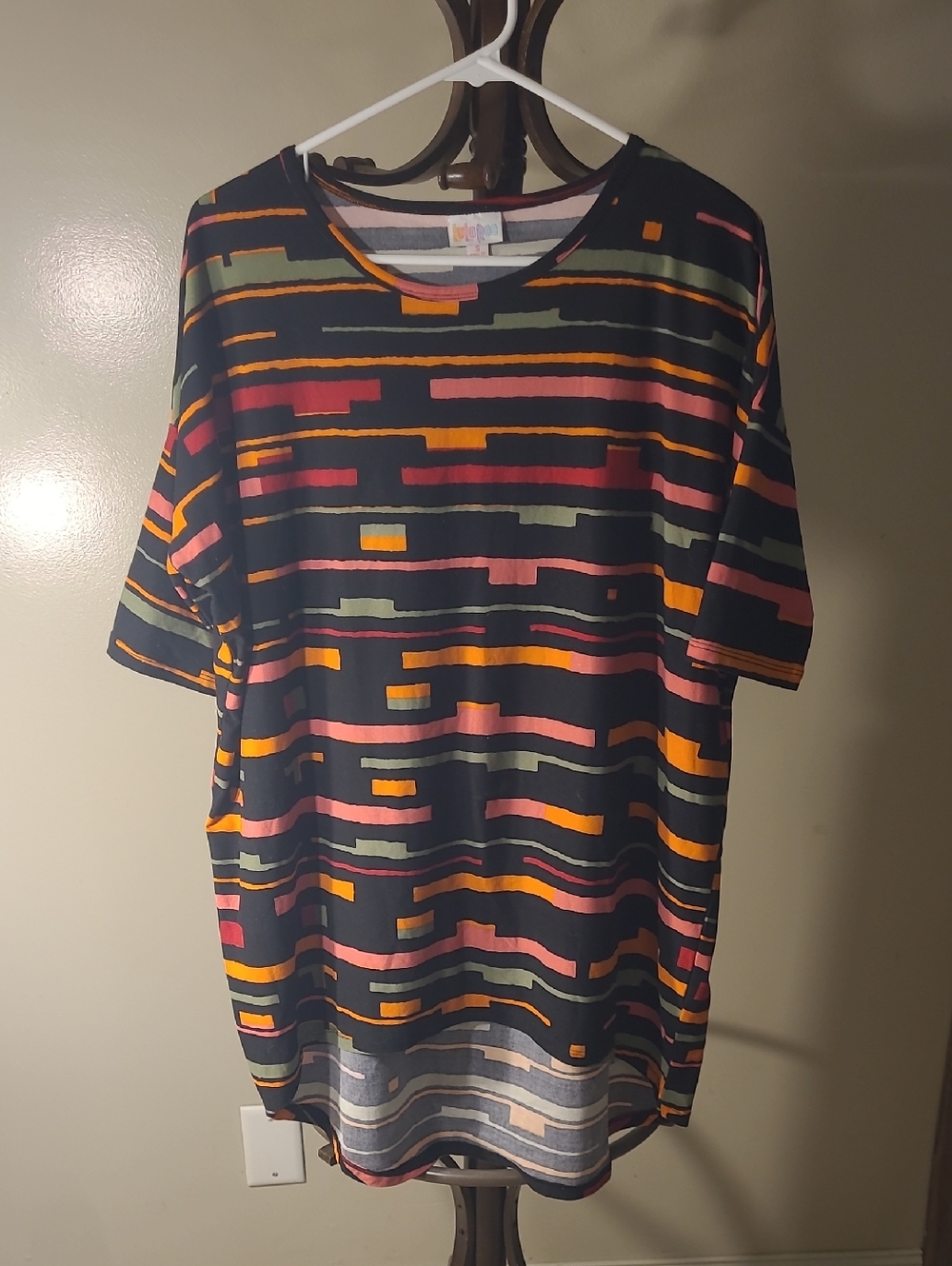 LuLaRoe Irma tunic top in a black multi-colored geometric pattern